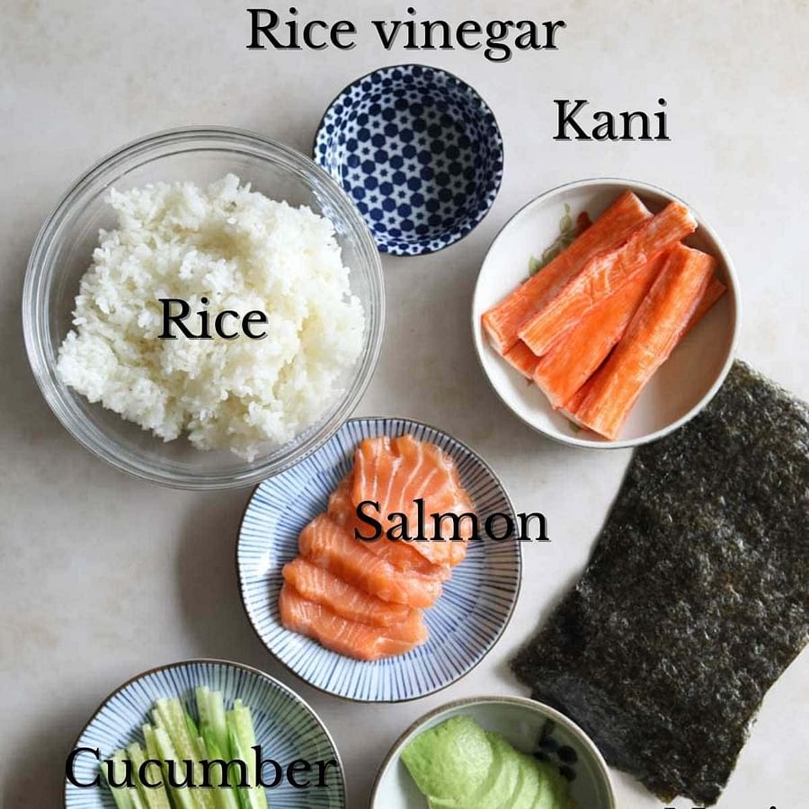 Assortment of fresh sushi ingredients including sushi rice, nori, and sushi-grade fish