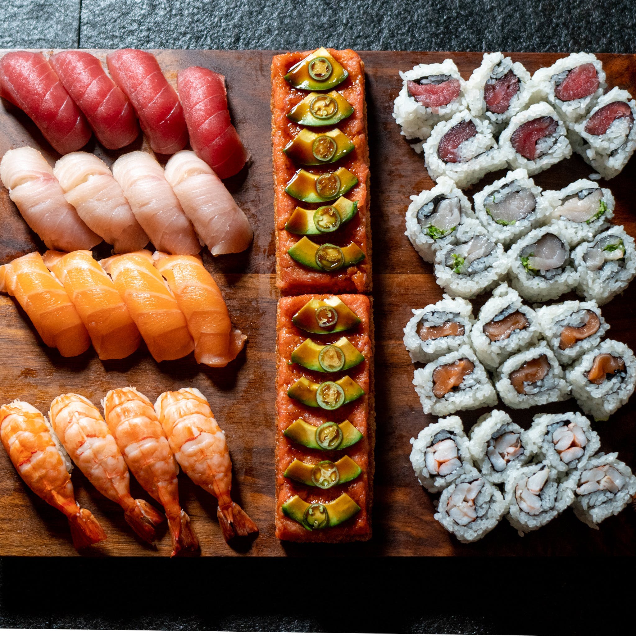 Beautifully sliced sushi platter with garnish